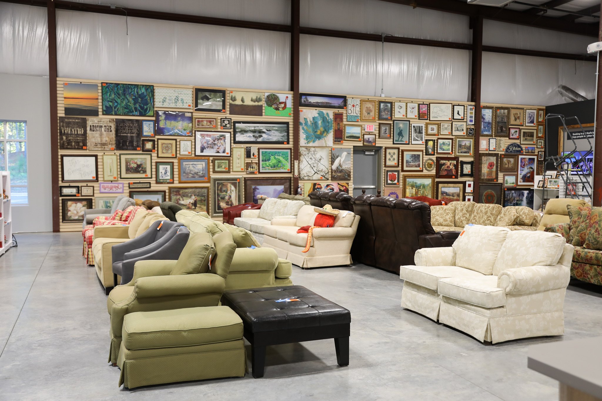 furniture aisle at the clayton restore with couches, art, home decor and more