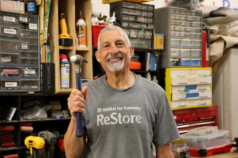 Volunteer Paul Leifer poses with hammer in the Brier Creek ReStore